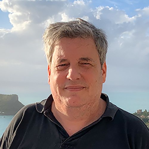 Peter standing on the beach in Calabria with his back to the sea